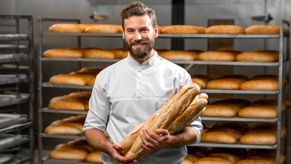 Employee holding baguettes